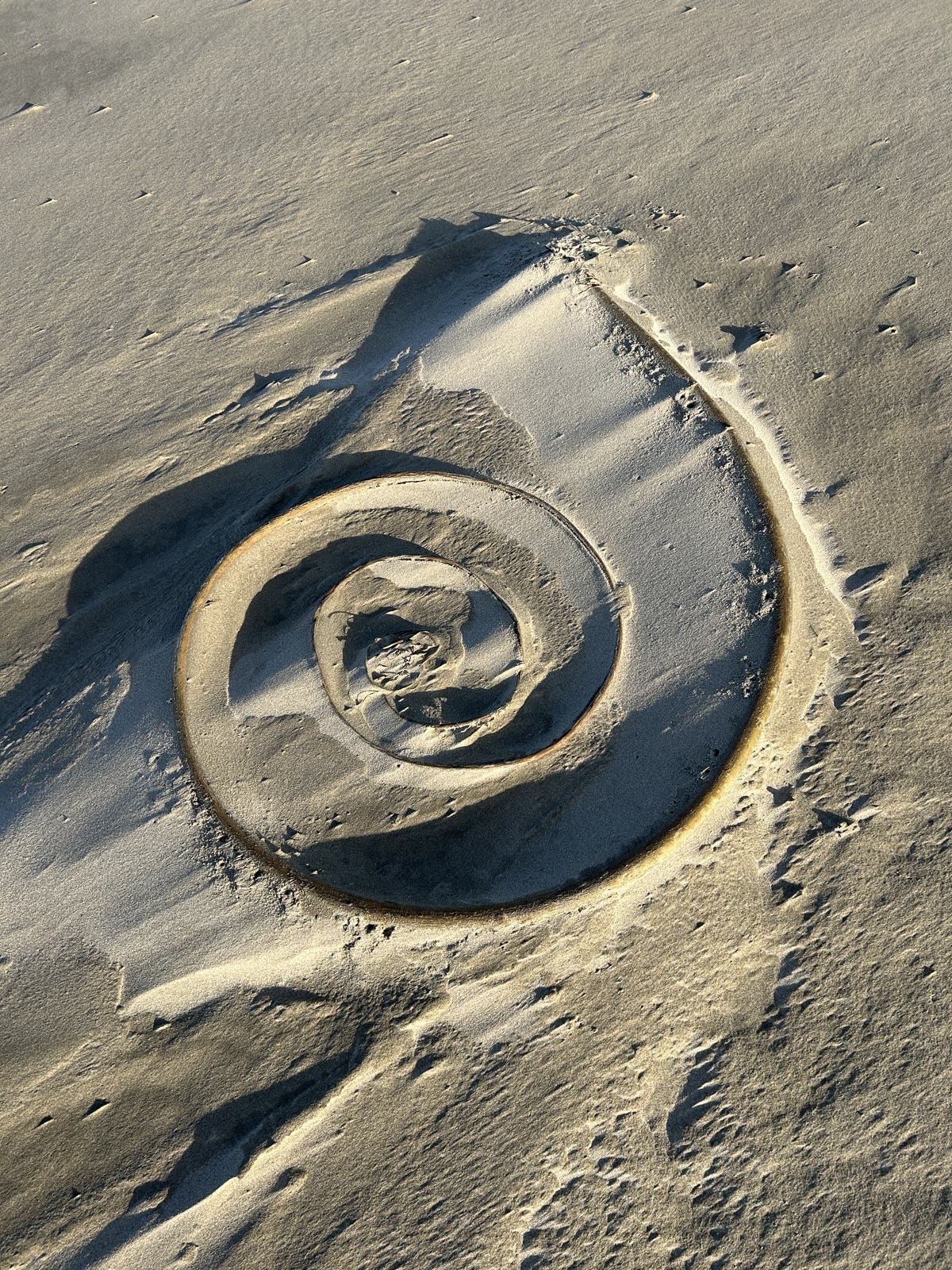 A spiral drawn in the sand